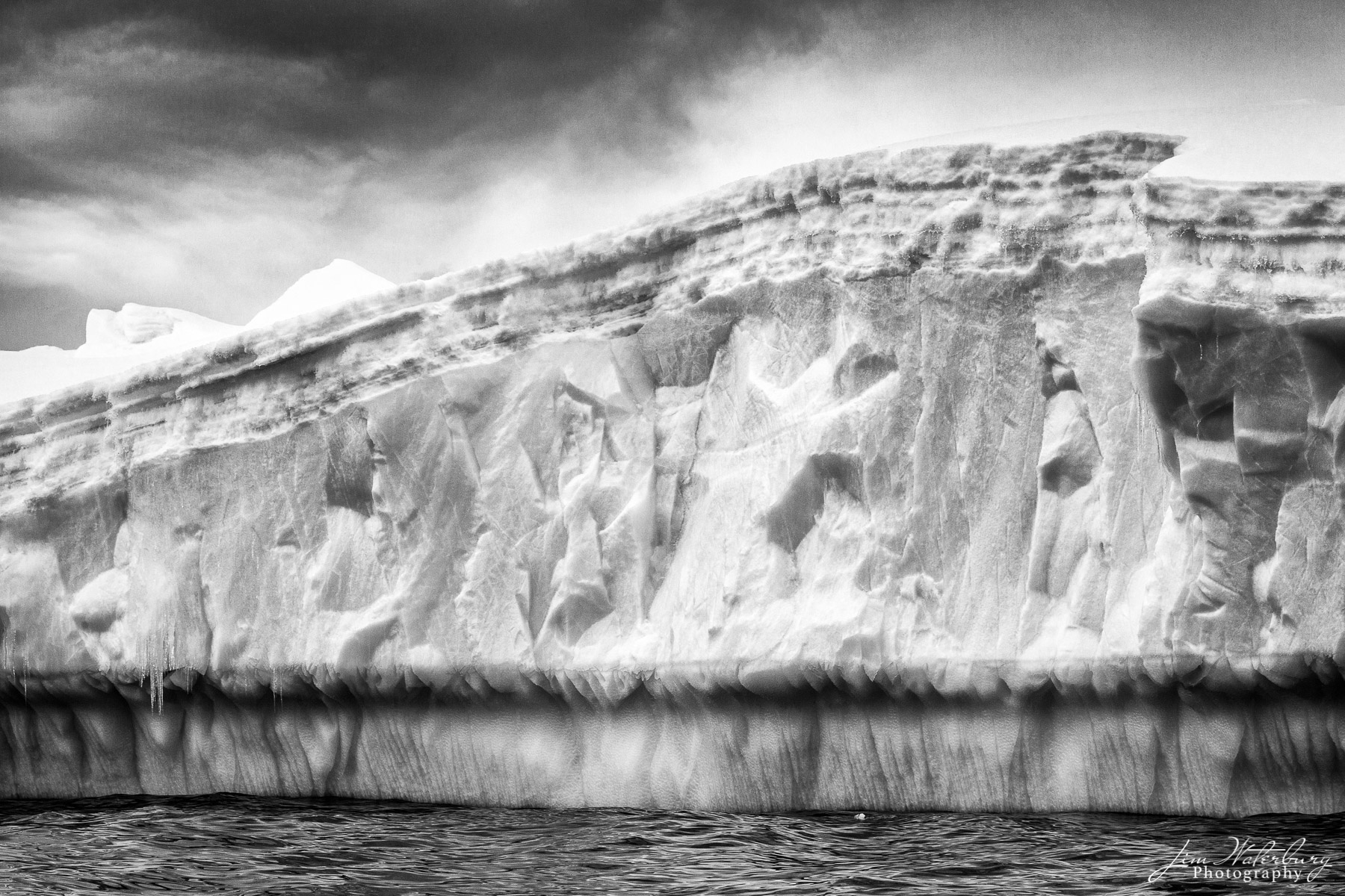 Black & white image of a large sculptured iceberg off of Cuverville Island.