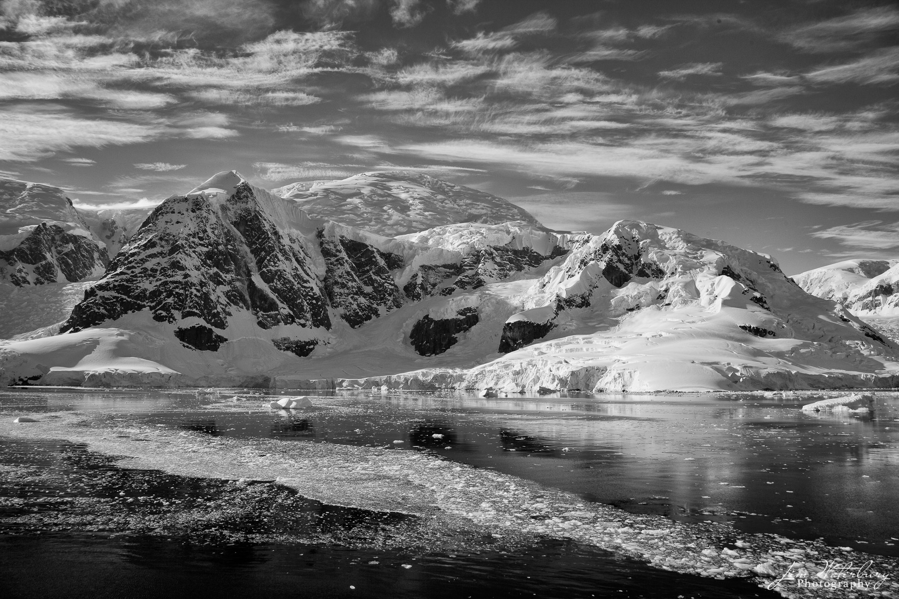 Paradise Harbour Black & white photograph of the waters off Paradise Harbour, rugged mountains and wind-swept skies.