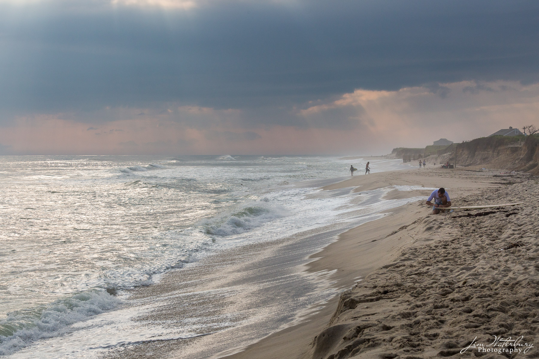 Getting Ready With waves rolling in, a surfer prepares his board, at Cisco Beach on a late summer afternoon.