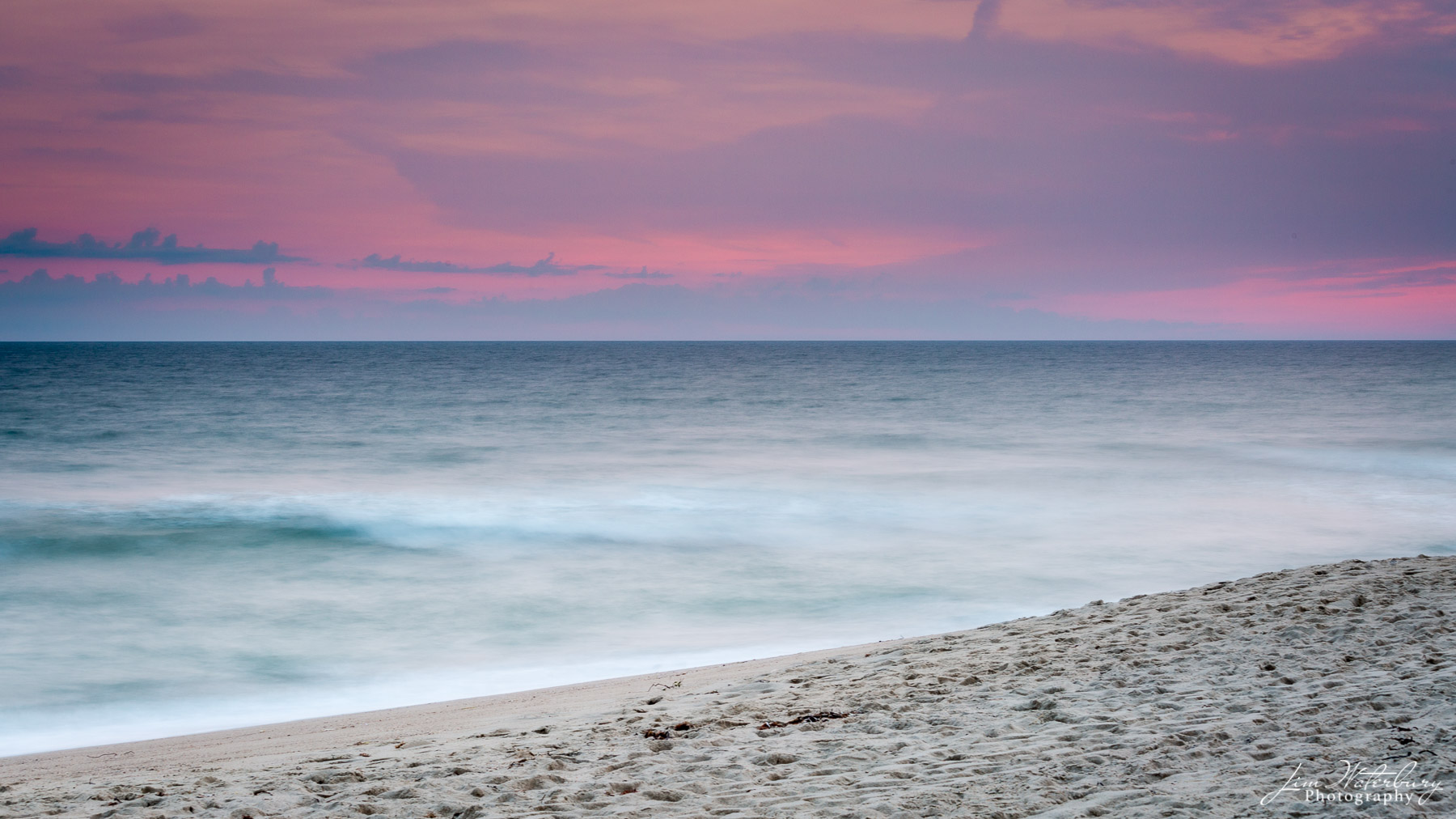 The sky lights up in hues of pink and purple over the ocean at sunset, near Lady's Beach, Nantucket.