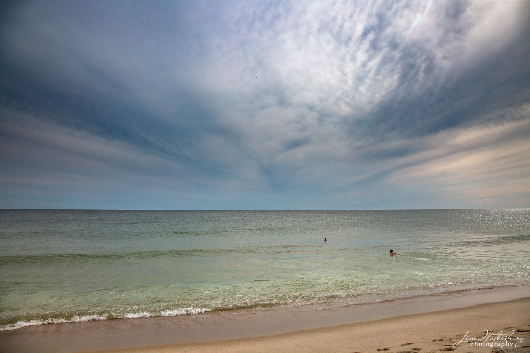 Late Swim A calm ocean attracts two swimmers under a stormy late afternoon sky in Nantucket.