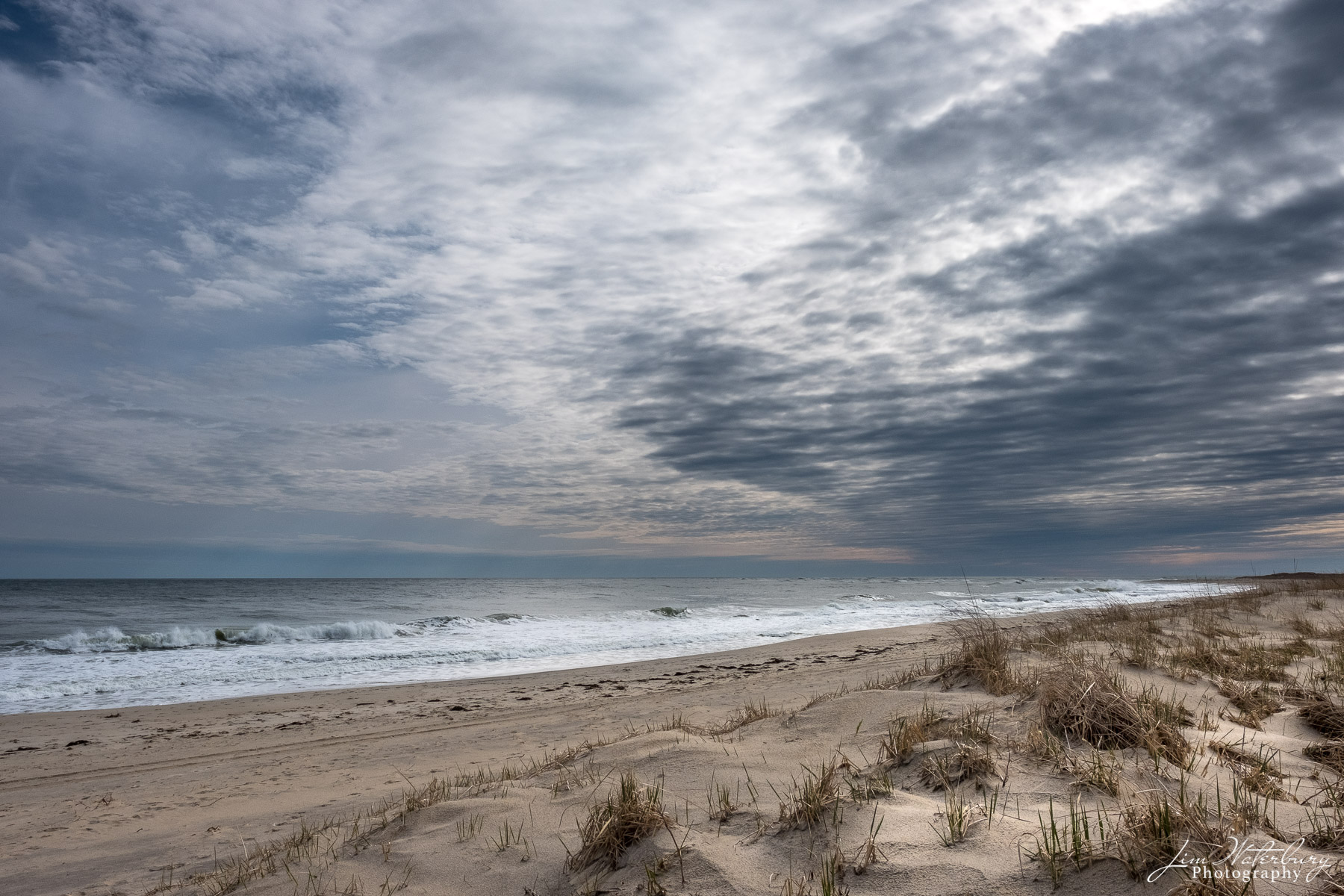 Ocean, beach and cloudy skies in Spring on Nantucket.