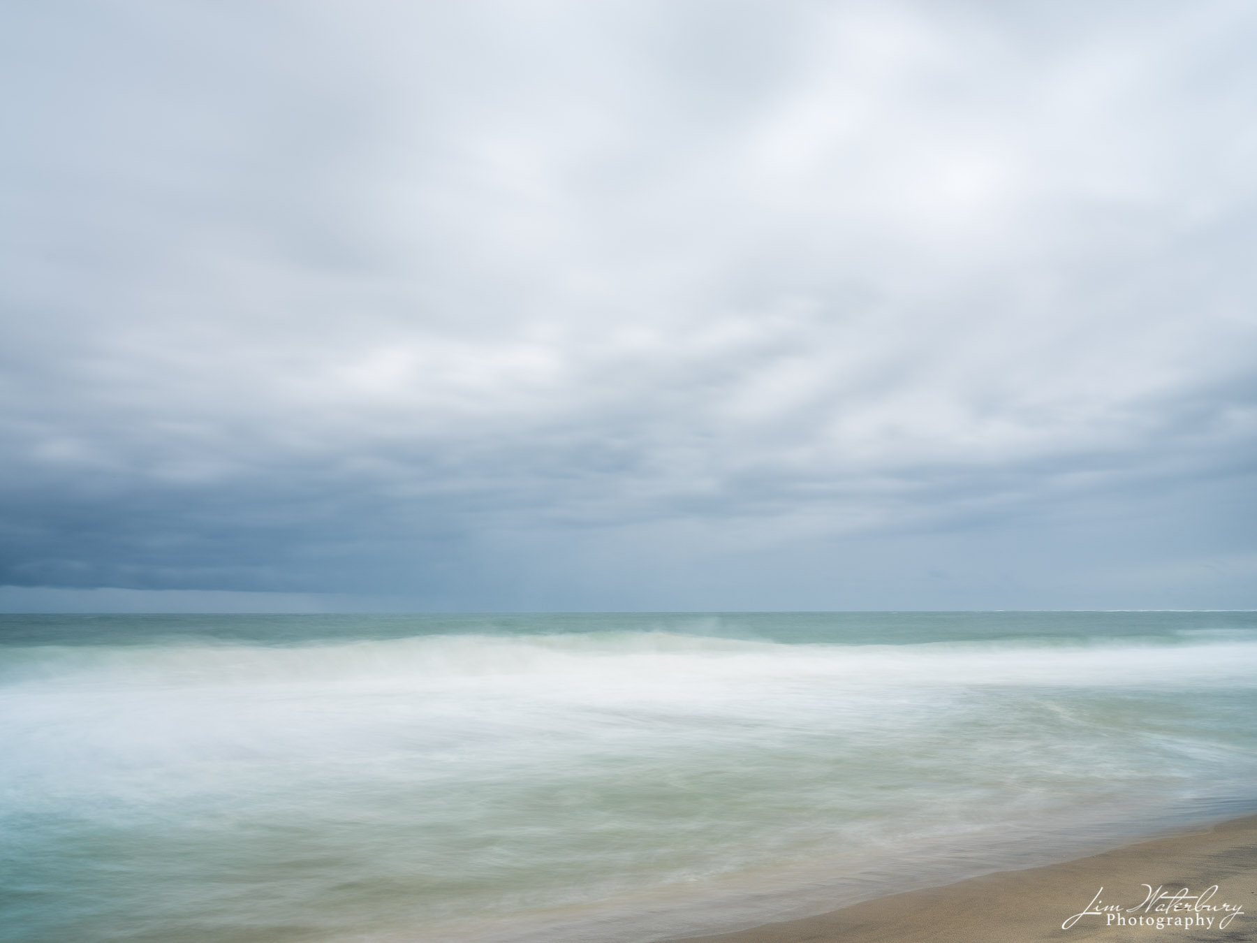 A long exposure blurs ocean and clouds off Cisco Beach, Nantucket.