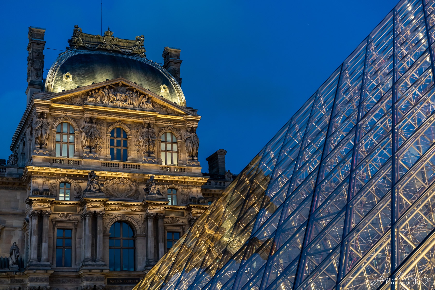 Windows of the Louvre Photographed at night, this image contrasts the windows of the magnificent, baroque-style Palais du Louvre, originally built...