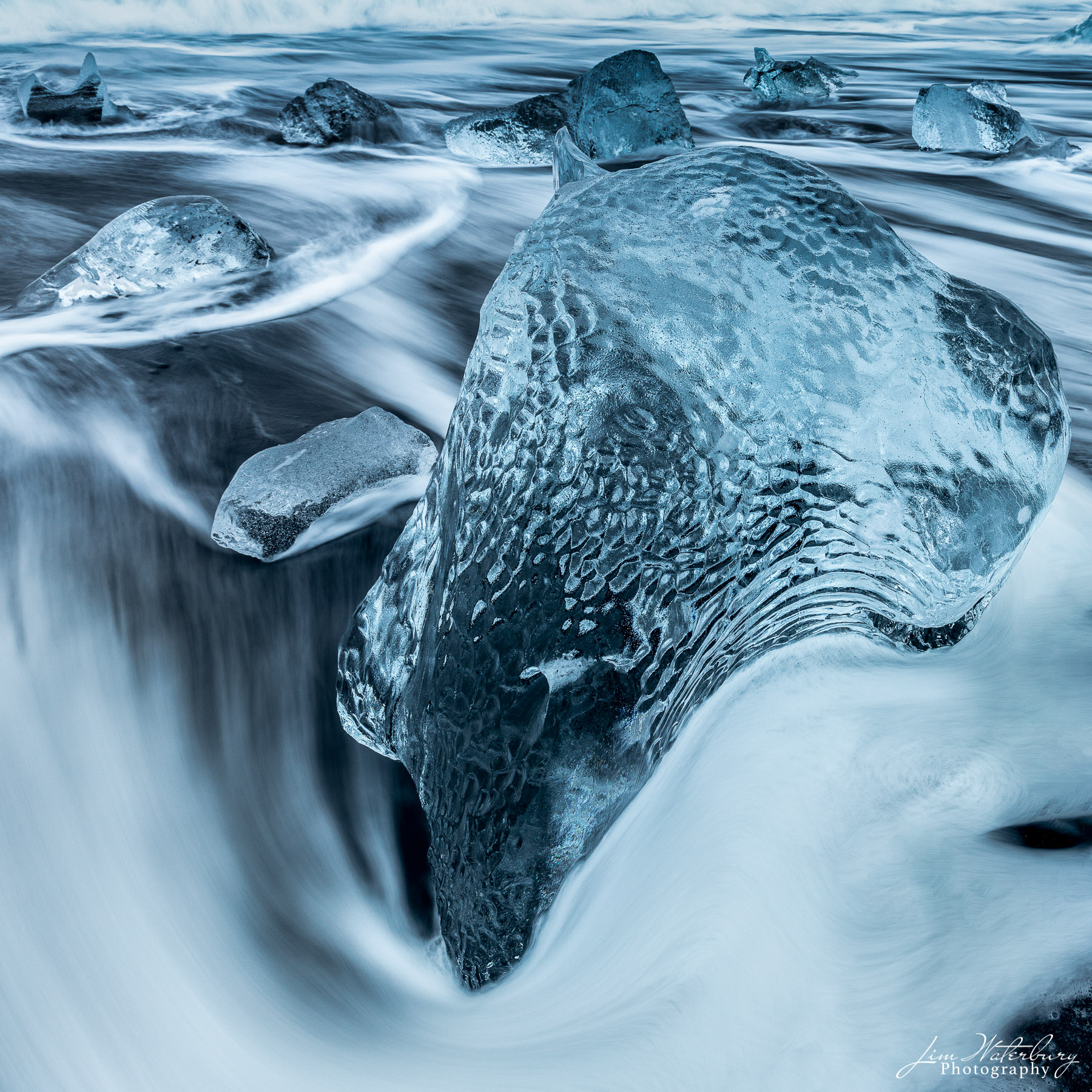 Ice Cliff Close up image of ice, shaped by the foam from a receding wave, on Fellsfjara Beach (Diamond Beach), near the Jokulsarlon glacial...