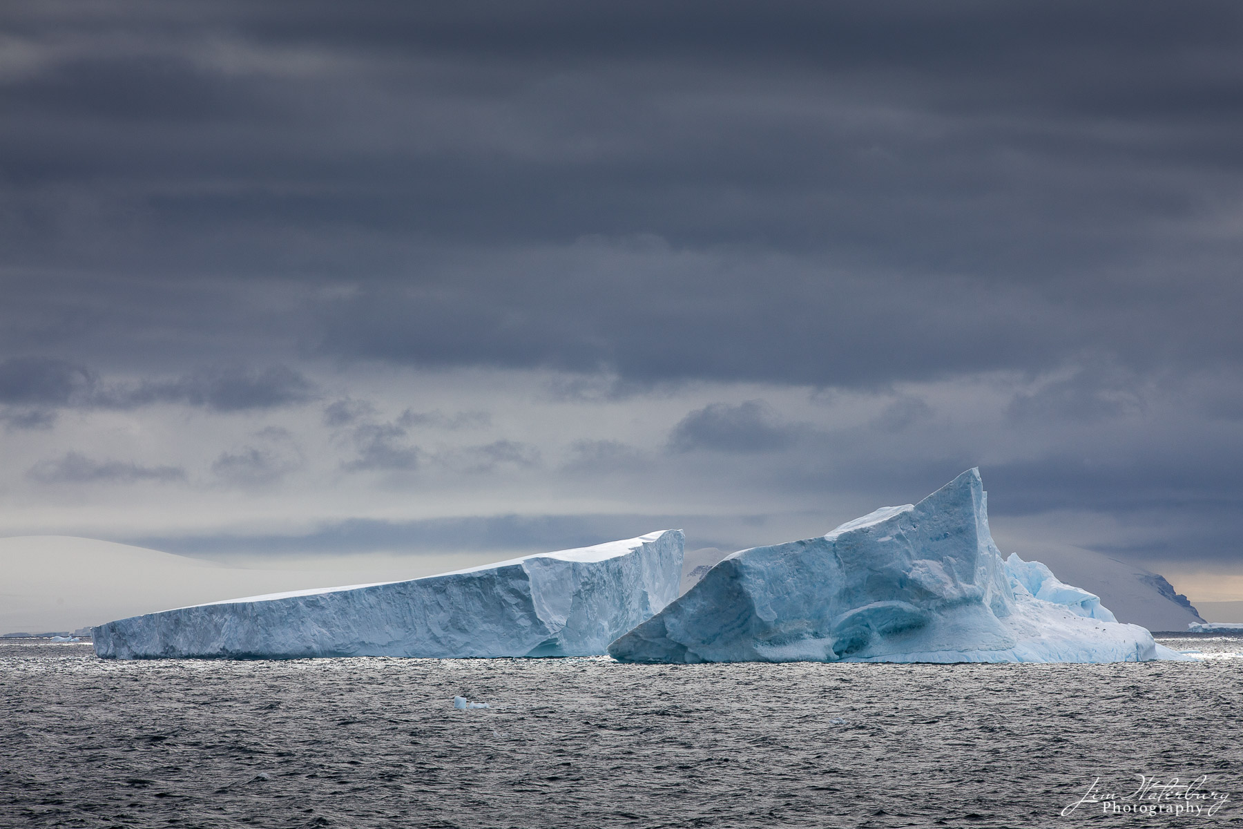 Broken Image of a large iceberg that appears to have broken in two and is now floating in the Antarctic Sound.