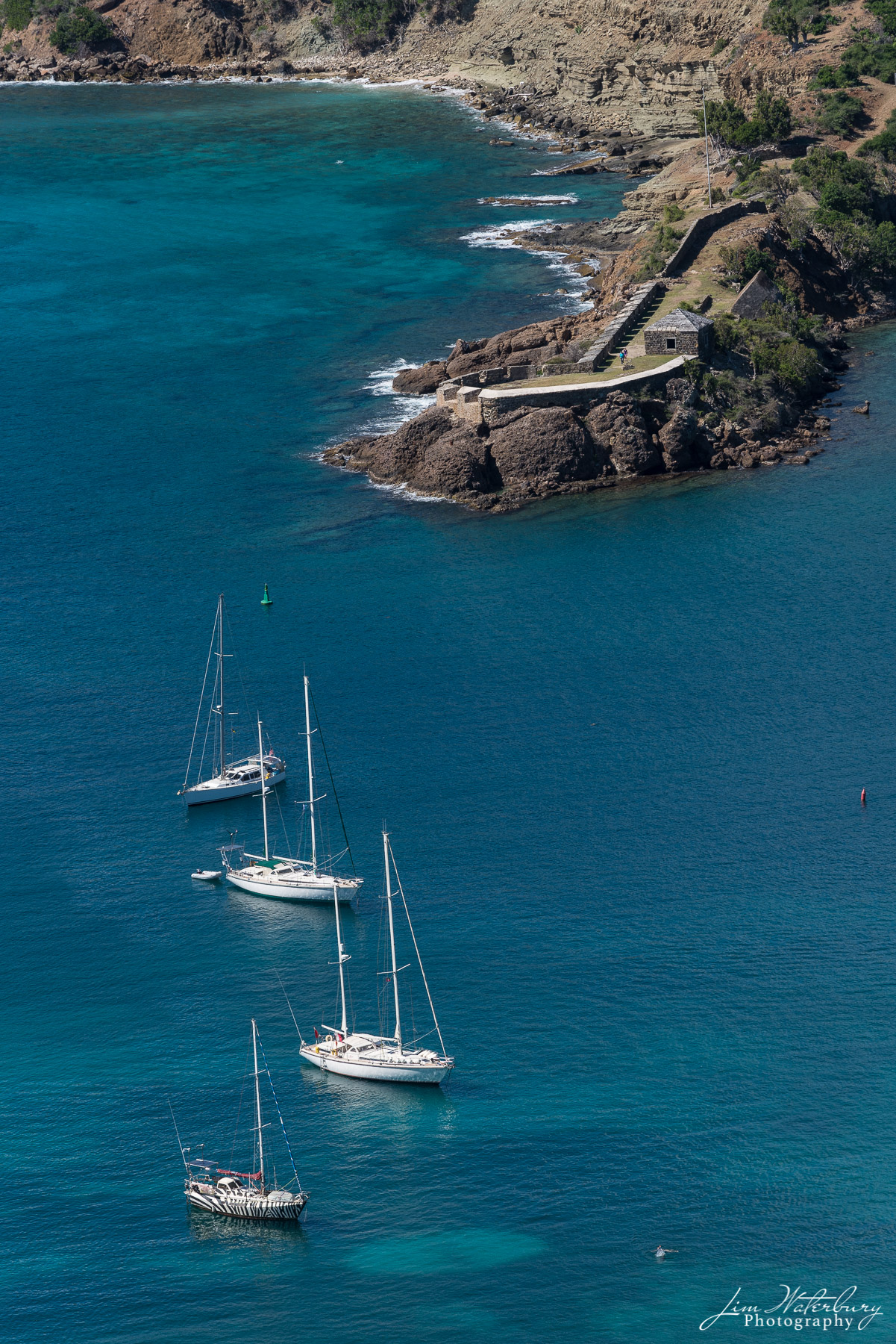 Sailboats moored across from Fort Berkeley, which was built in 1704 on a spit across from the entrance to English Harbor to defend...