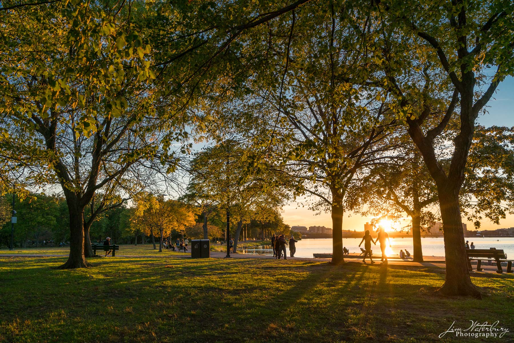 Evening Stroll A couple strolls along the banks of the Charles River in Boston as the sun sets on a perfect fall day.