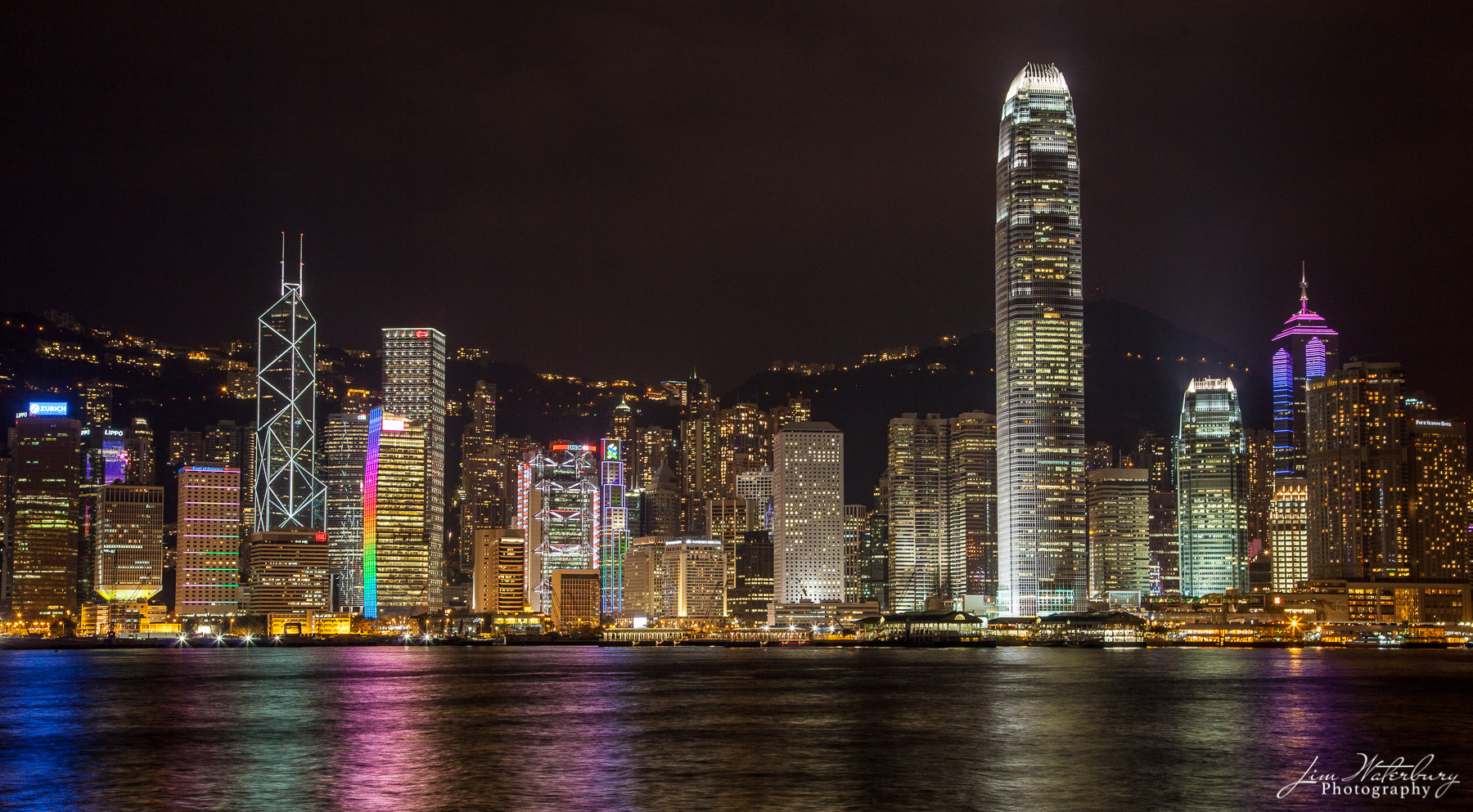 Skyscrapers View of the skyscrapers of Hong Kong, illuminated at night, from a boat on Victoria Harbor.