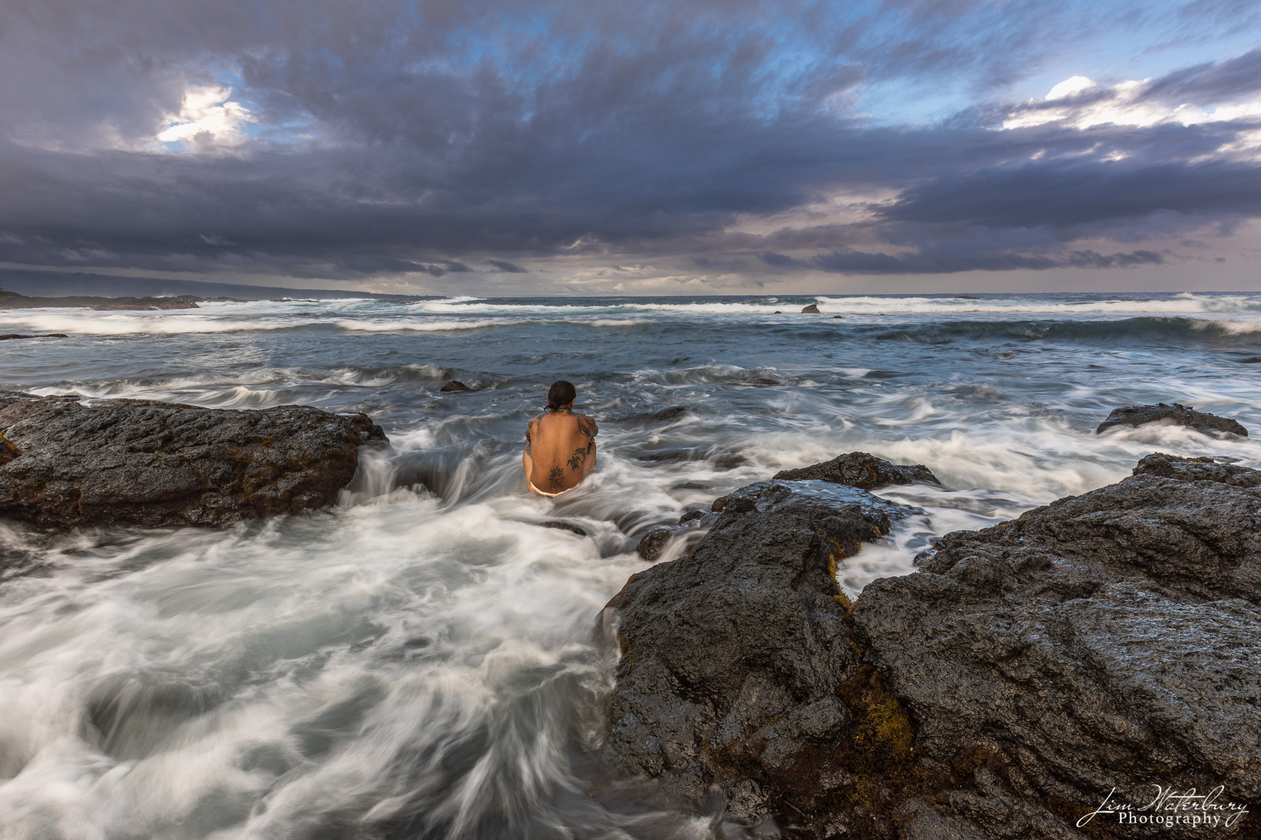 Into the Sea A local Hawaian looks out into the vastness of the Pacific Ocean, from the rocky shores near Hilo, on the Big Island of Hawaii...