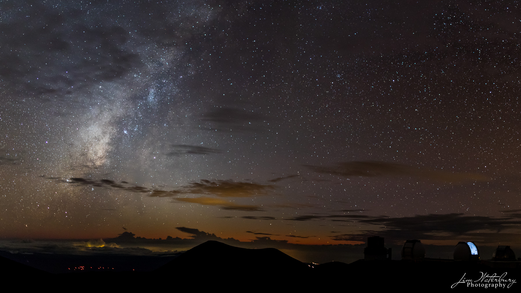 This panoramic image, taken shortly after sunset from the summit of Mauna Kea, Hawaii's tallest mountain, shows the Mauna Kea...