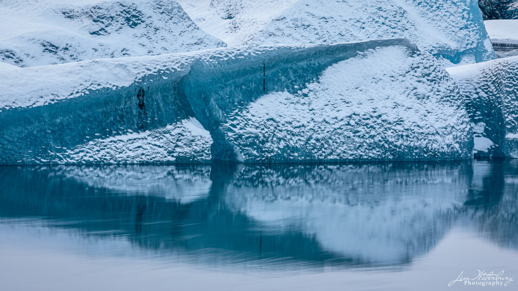 Triangles Ice and snow on icebergs, reflected in the clear waters of the Jokulsarlon glacial lagoon, form numerous triangular shapes.