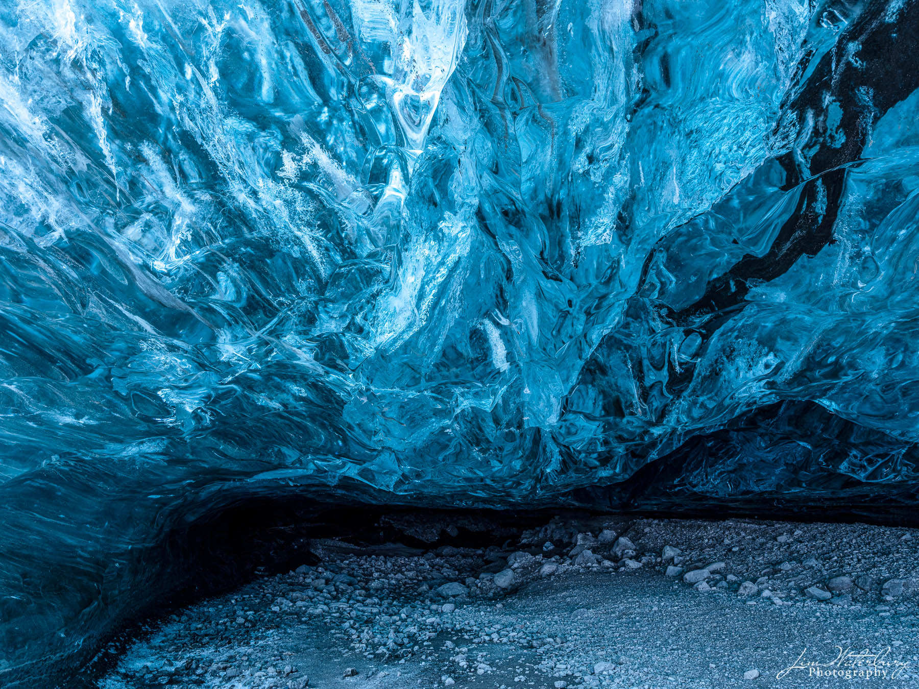 Into the Cave Blue ice at the entrance to an ice cave in the Breidarmerkurjokull outlet glacier (Vatnajokull), Iceland in winter.