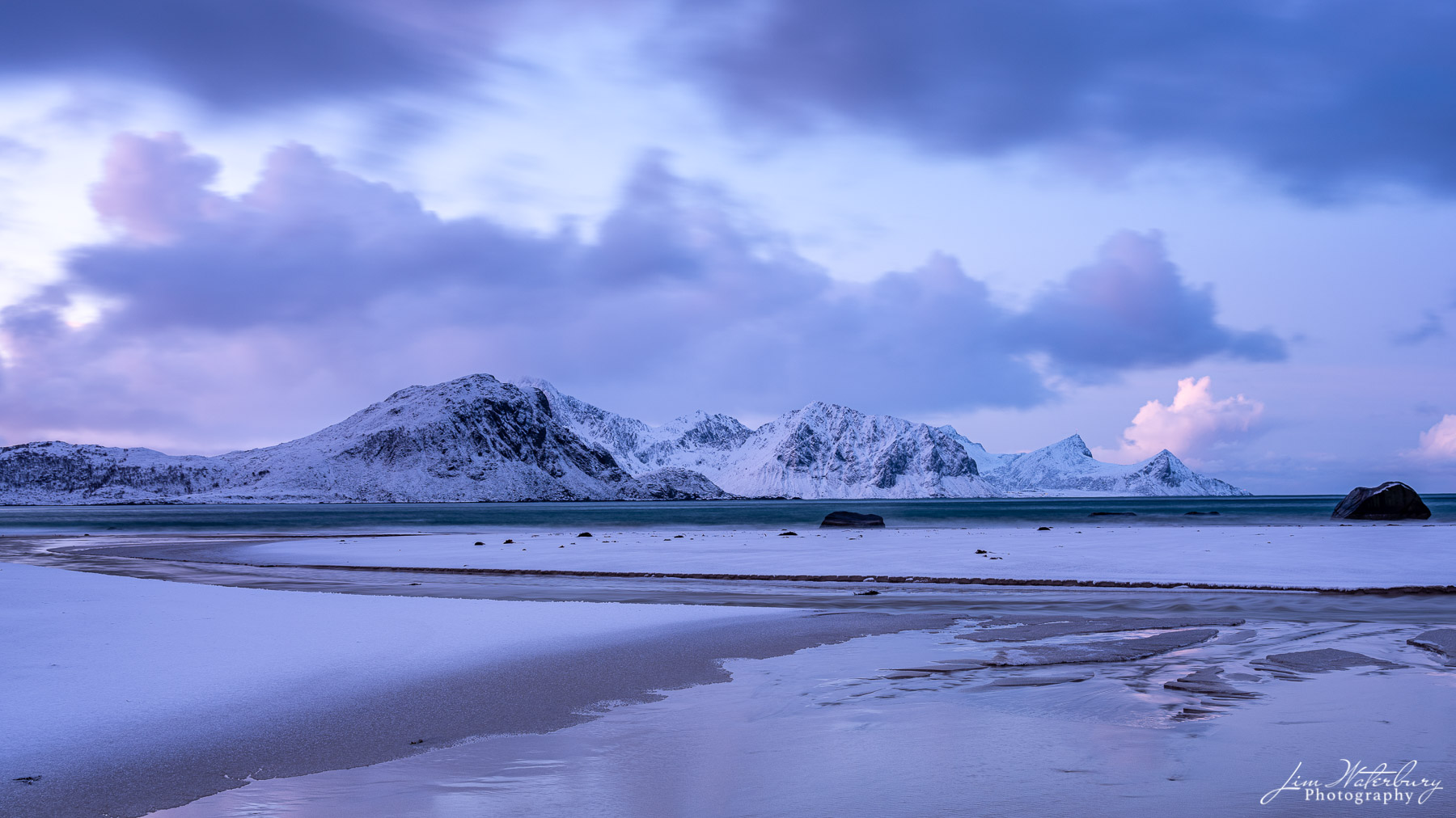 Frosty Beach In the early dawn light, a light dusting of snow, combined with sand and surf, forms interesting patterns at Haukland Beach...