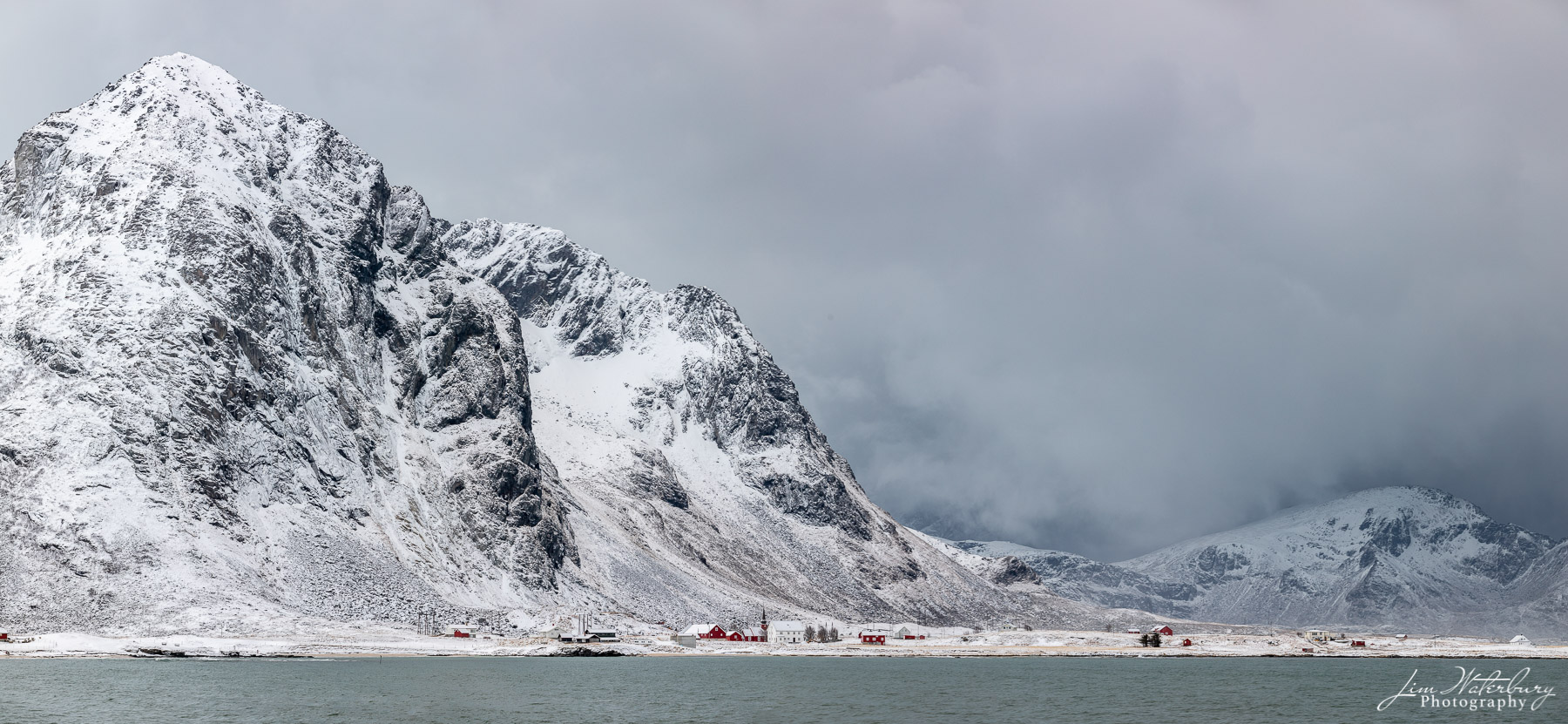 Secluded Village Winter view of a tiny, remote village from near Vareid, looking across the bay at Flakstad, Lofoten, Norway.