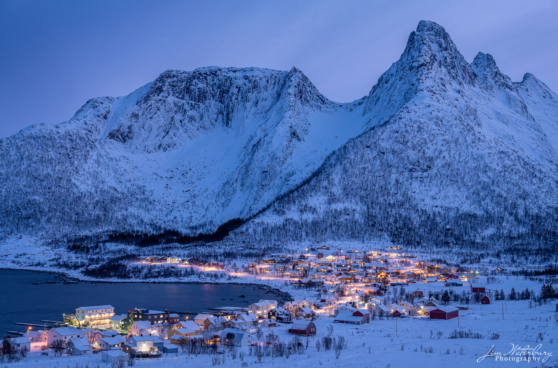 Night falls over the village of Mefjordvaer on the island of Senja in the Lofoten Islands in winter.