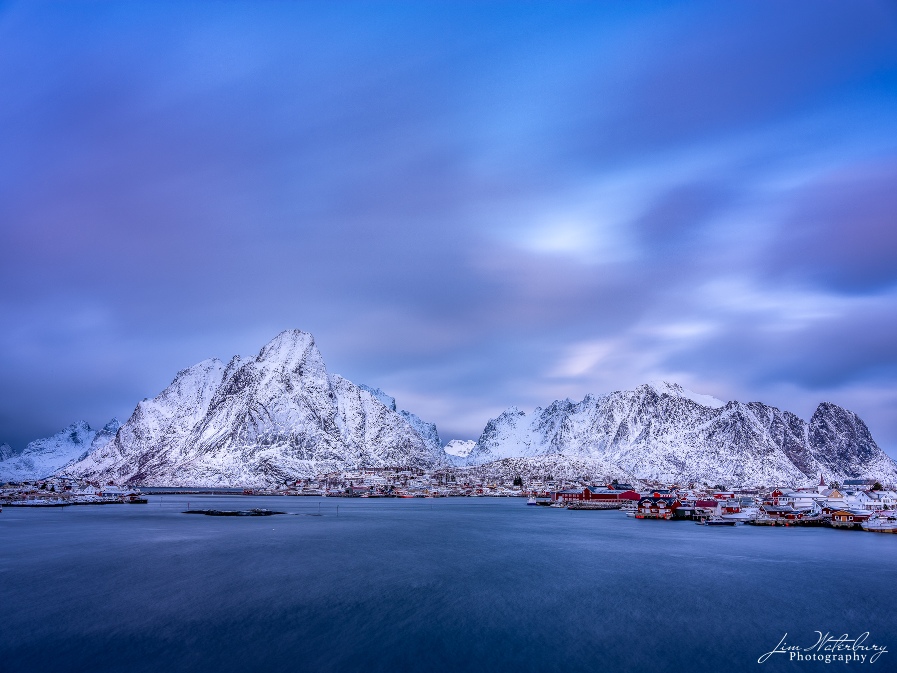 Lofoten Dusk Winter view of the fishing village of Reine, with its traditional fishing cottages, at dusk.