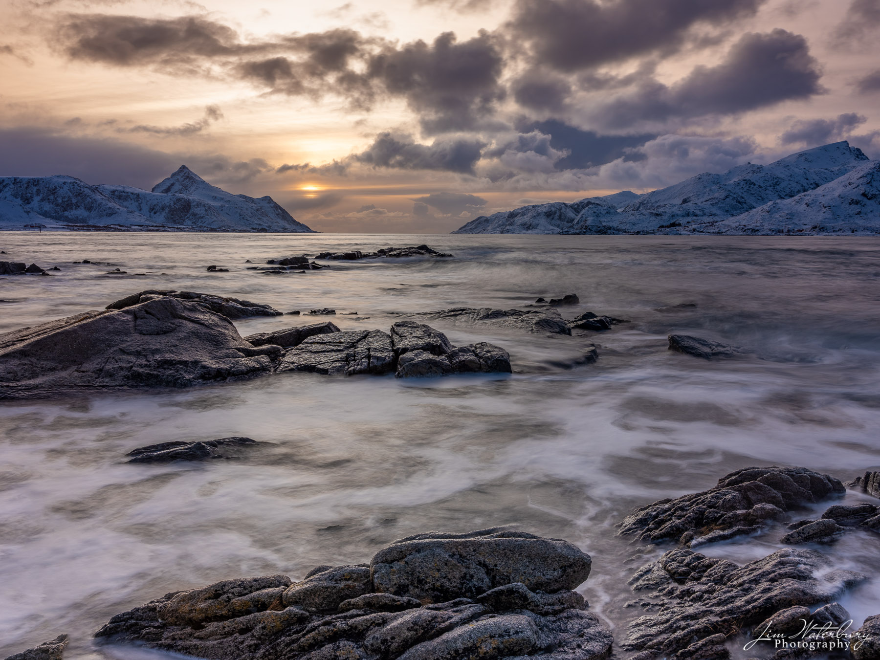 Rocks and Foam Layers of foam, rock, and clouds form a moody, late afternoon winter seascape across a fjord near Leknes in the Lofoten Islands...