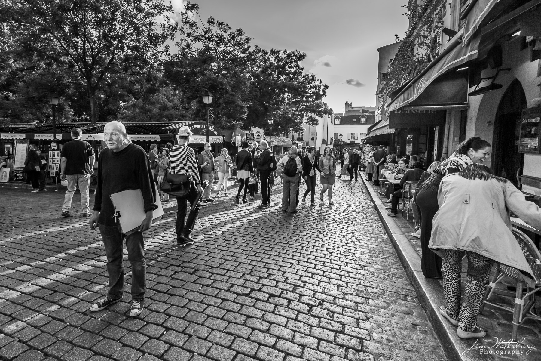 Artists and tourists mingle in Place du Tertre in Montmartre, Paris.  Black & white.
