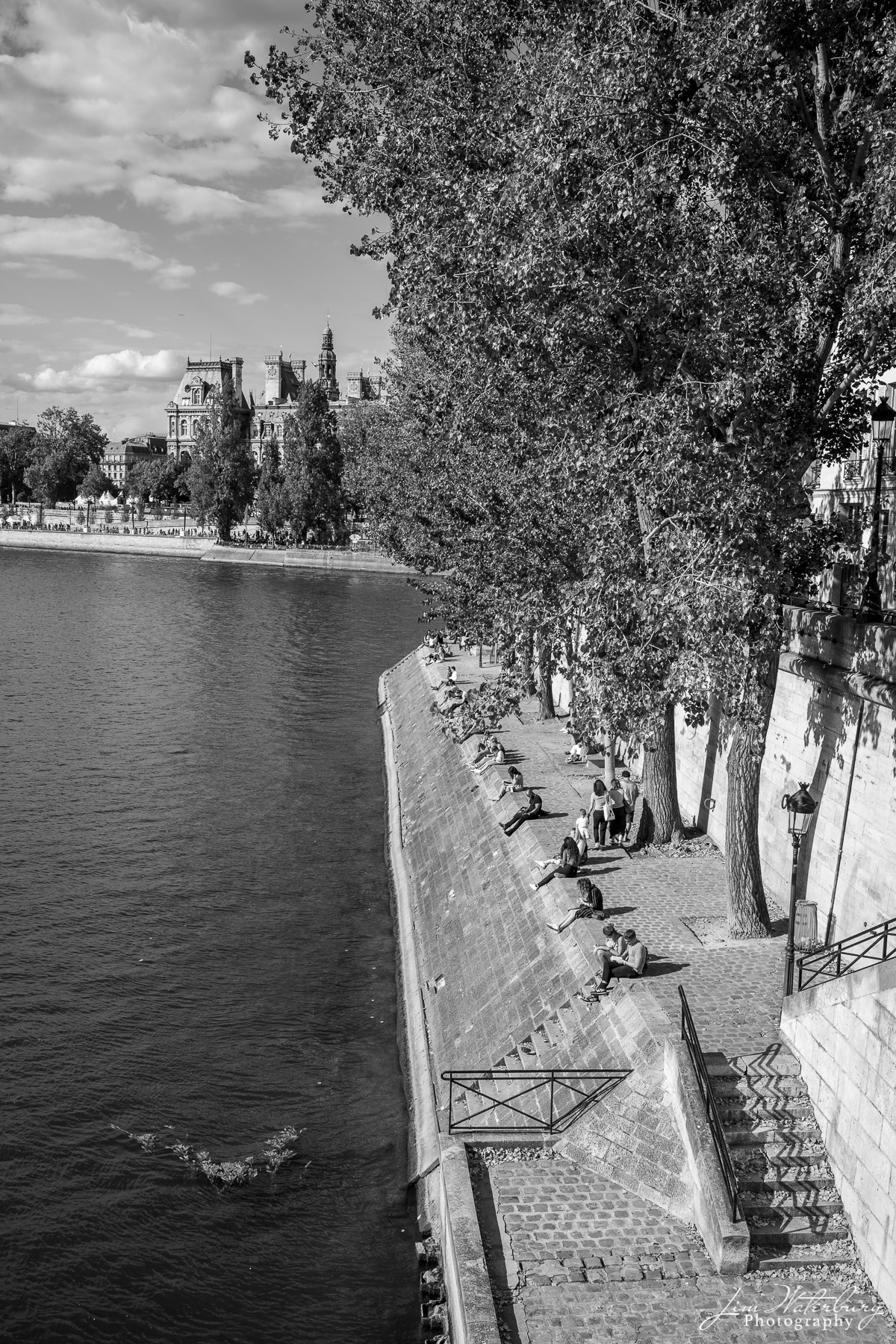 Study Hall Students take advantage of a warm fall day to sit along the banks of the Seine. Black & white.