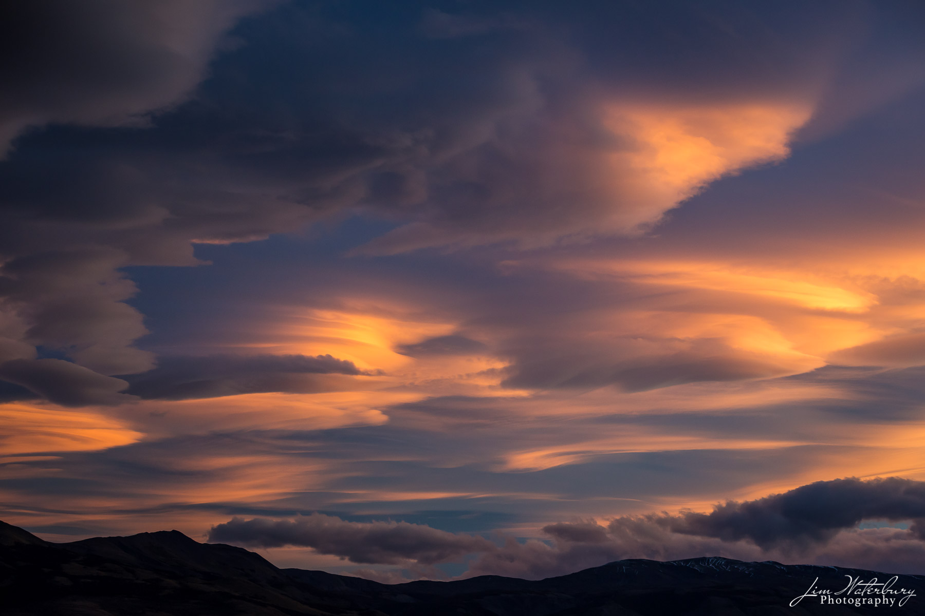 Heavenly Clouds #4 A series of lenticular clouds glow in the late afternoon sun in Torres del Paine National Park, Patagonia.