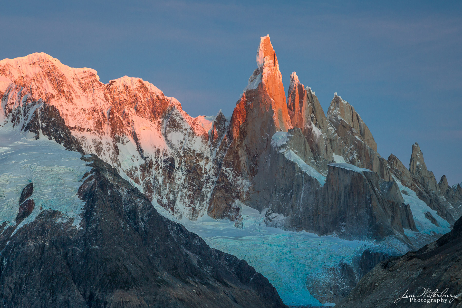 Cerro Torre Alpenflow Sunrise over Cerro Torre Massif, Patagonia. Cerro Torre itself is a 10,262-foot-high, sheer-walled granite tower on the border...