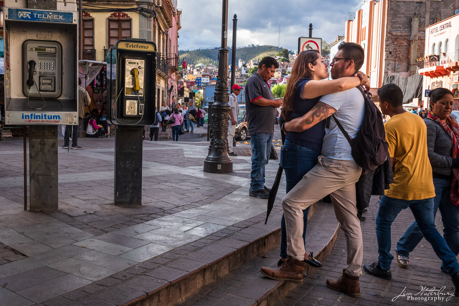 A couple embraces on a busy street corner in Guanajuato, Mexico.