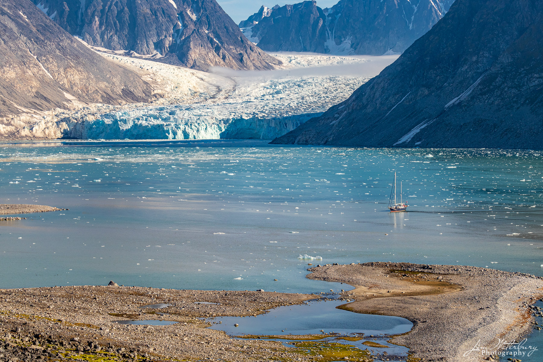 Arctic Sail A sailboat cruises the high arctic n the waters of the Magdalene fjord, Nordvest-Spitsbergen National Park, Svalbard.