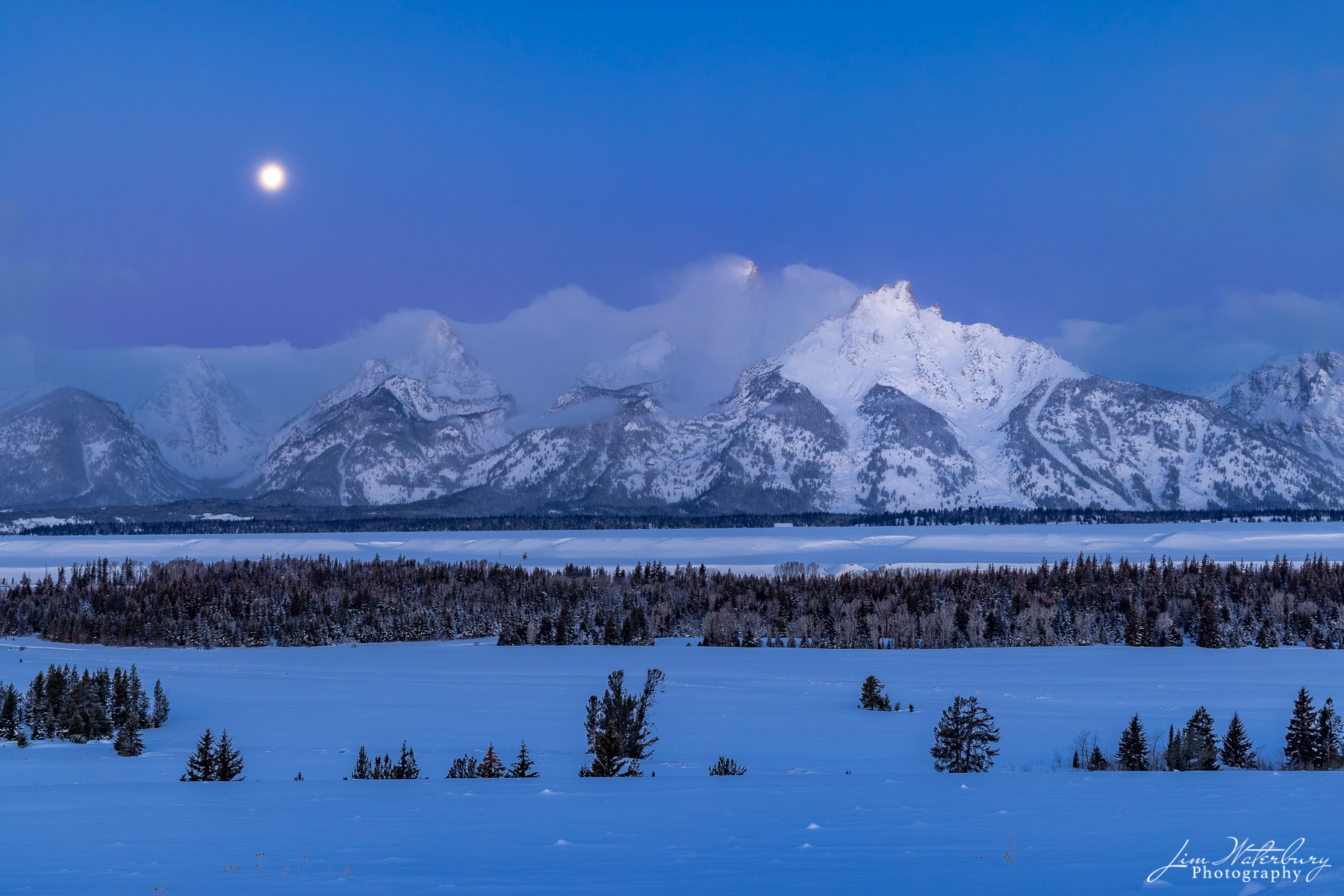 Tetons at Dawn Teton Range, in the pre-dawn light, with the full "snow" moon of February about to set.