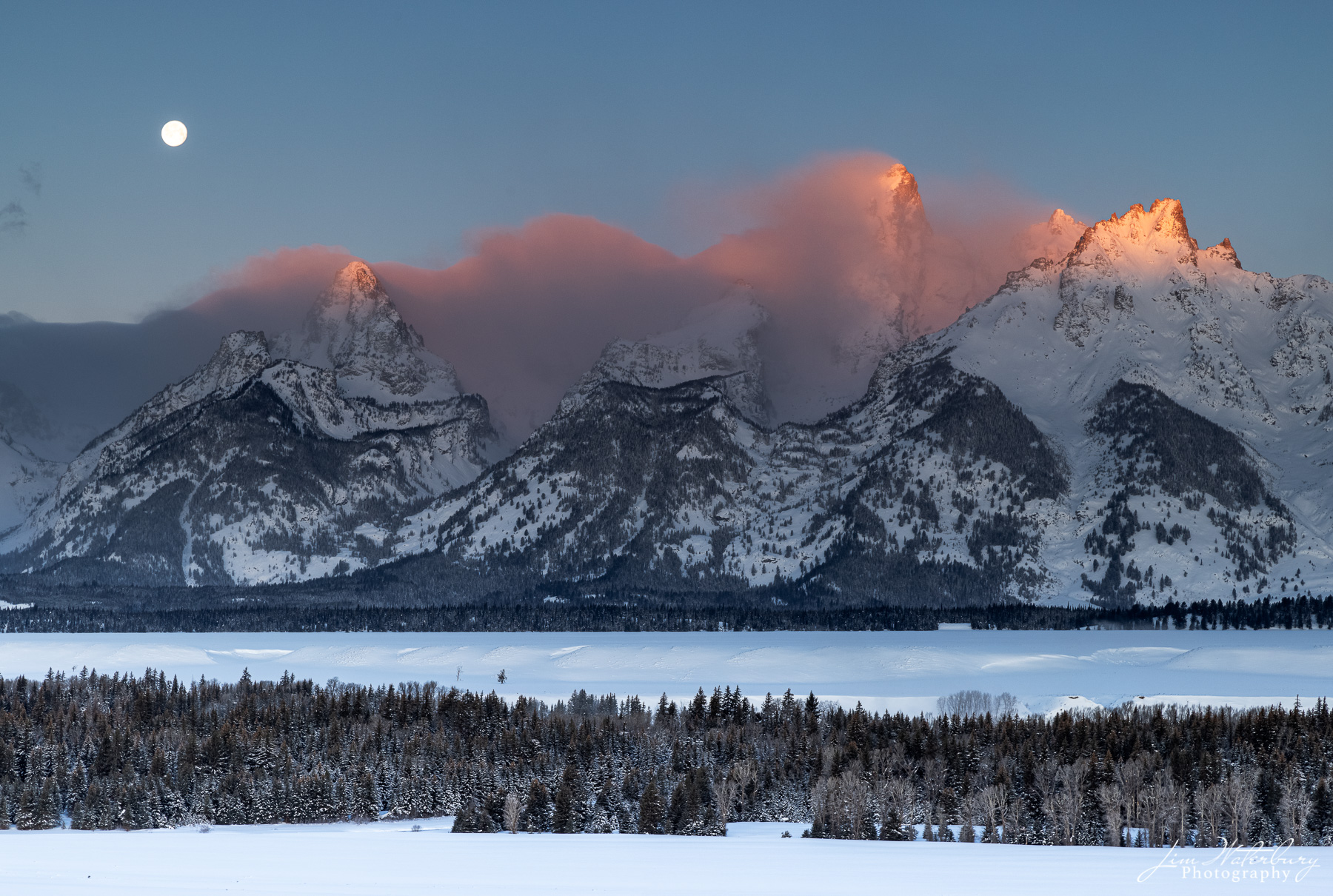 Moonset, Sunrise Alpenglow on the Teton Range at sunrise, as the full "Snow" moon of February sets.