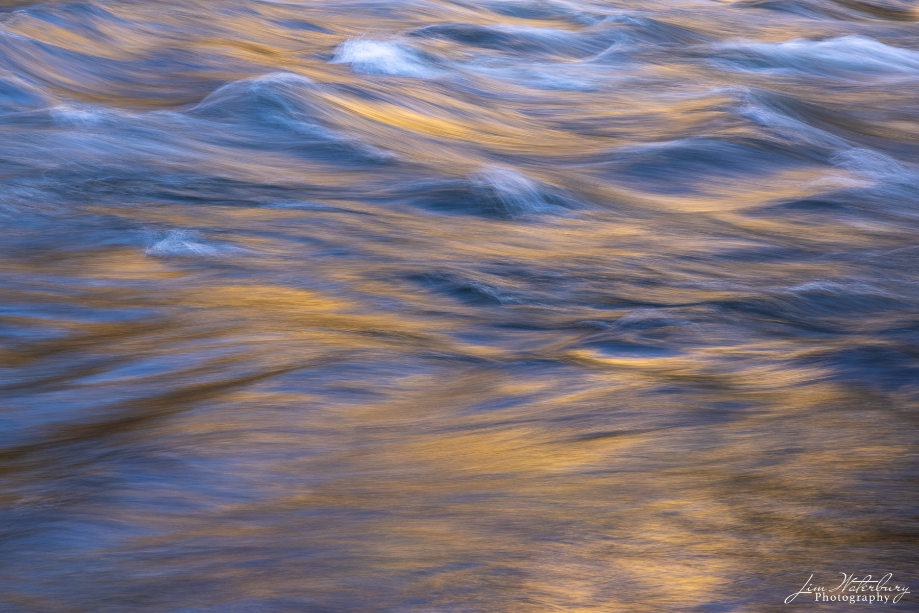 Abstract of rushing water in the Merced River, with soft evening light reflected off the surrounding cliffs.