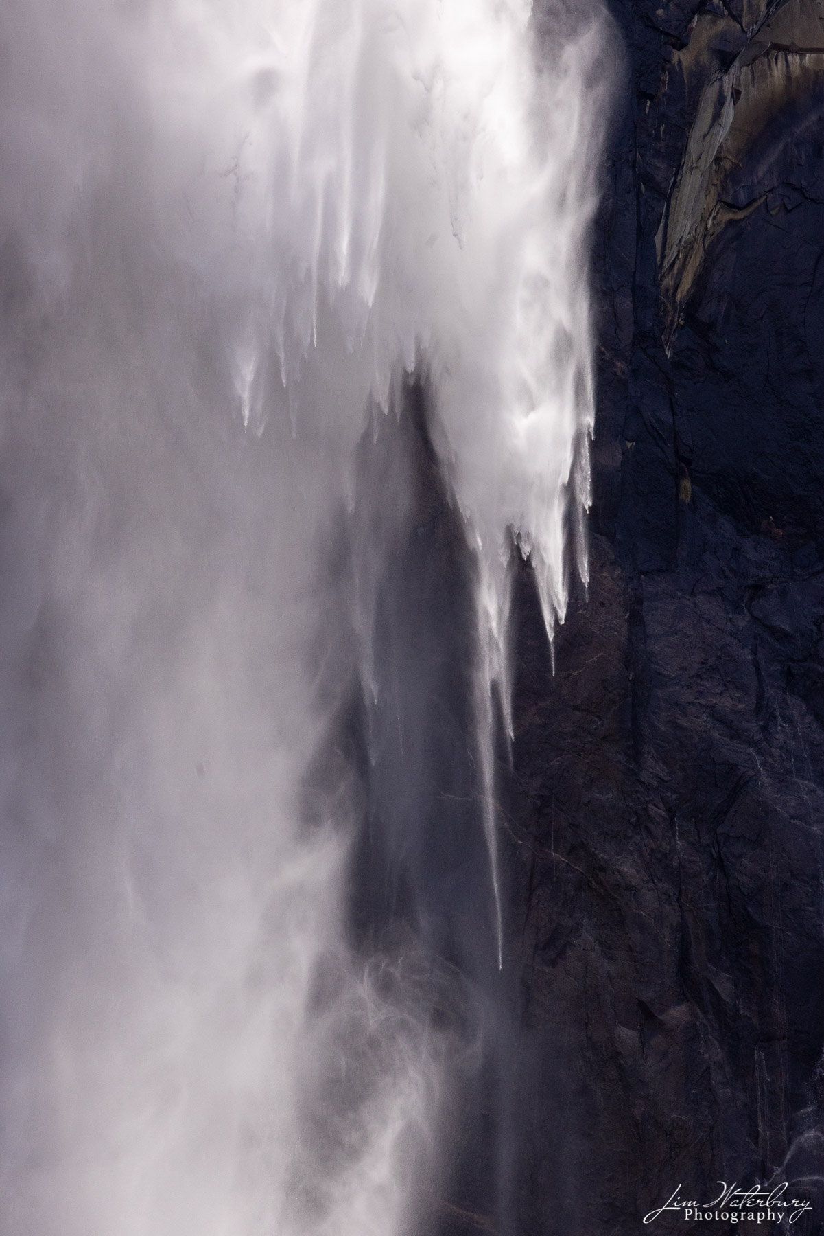 Detail of water and spray descending from Bridel Veil Falls, photographed from across the Merced River